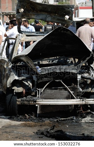 CAIRO - SEP 05: Demonstration one of the exploded cars belongs to the interior minister\'s convoy after the explosion that was targeting Minister in Mostafa Nahas st. Cairo, Egypt on September 05, 2013
