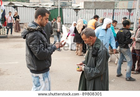 CAIRO – NOVEMBER 29: An unidentified Egyptian volunteer checks the national ID of an unidentified man before going in Tahrir Square during Egyptian parliamentary election in Cairo, Egypt on November 29, 2011