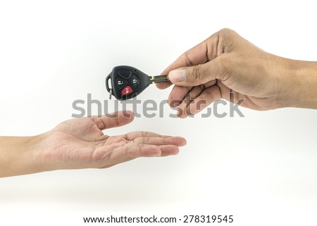 Send car key in hand isolated on white.