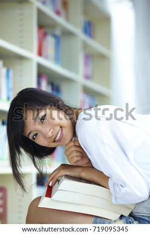 one pretty Chinese college student in the library