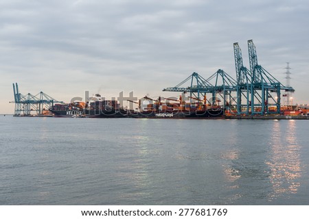 BELGIUM - SEPTEMBER 16: Port of Antwerp in the twilight with containers and cranes on September 16, 2011 in Antwerp