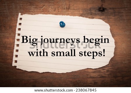 Text big journeys begin with small steps on note paper