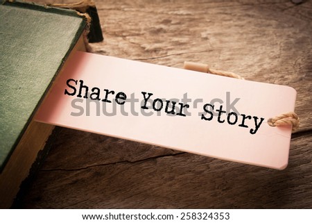 Share your story written on the paper on a wood background