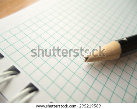 pencil with broken tip on blank paper; disappointment