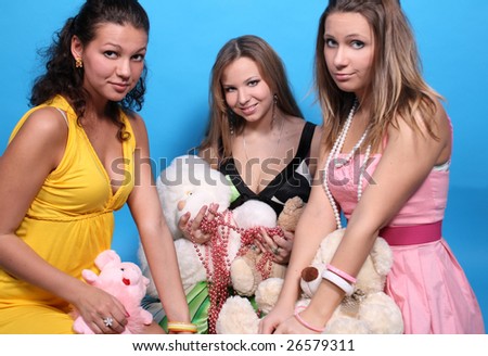 Three female friends with beads and teddy bears