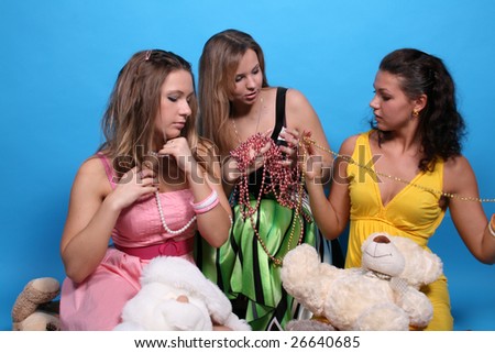 Three female friends among beads and teddy bears