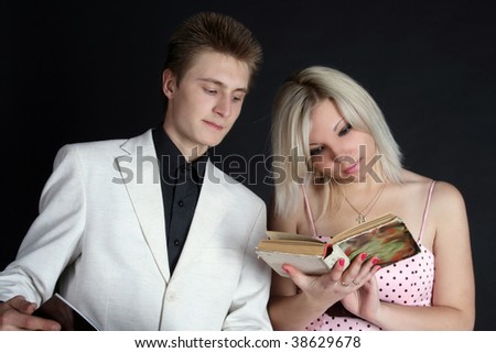 Two friends reading a book