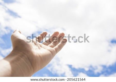 Man hand reaching out towards the sky