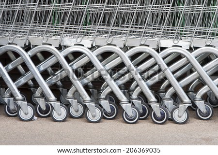 Wheel of Shopping carts on a parking lot . Detail of a shopping cart.