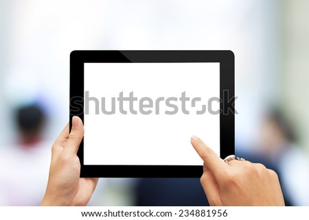 male teen hands with ring using tablet pc on blurred people background