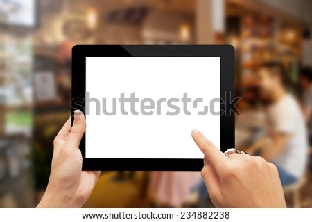 male teen hands with ring using tablet pc on blurred cafe background