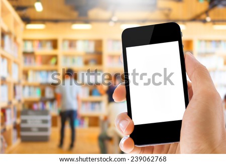 hand holding smart phone on library background