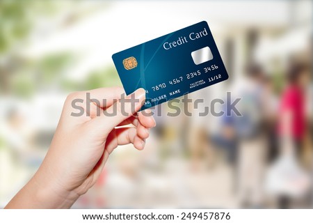 female  hand holding credit card