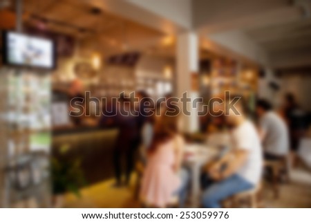 blurred background of sitting people in coffee cafe