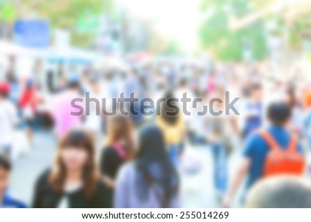 Crowd of anonymous people walking on busy Chiang Mai street, blurred people