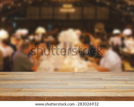 Empty wooden table and blurred dinning people background, product display