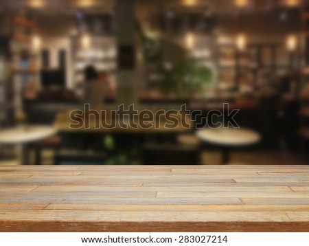 Empty wooden table and blurred cafe background,product display