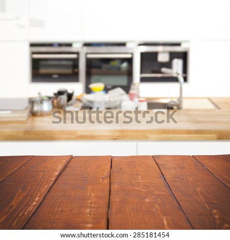 Empty wooden table and blurred kitchen background, product display