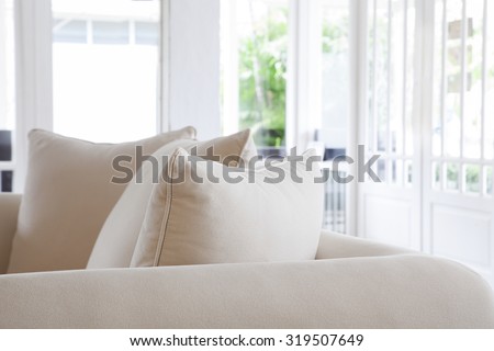Close up pillows on gray sofa room interior decoration background,white and bright tone,copy space
