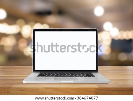 Laptop with blank screen on table. interior background, blurred background