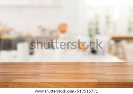 Empty wooden table and white modern kitchen cafe background,rasturant. Ready for product montage