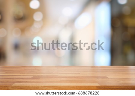 Empty wooden table and blurred  modern kitchen cafe background, restaurants. Ready for product montage, bokeh , light