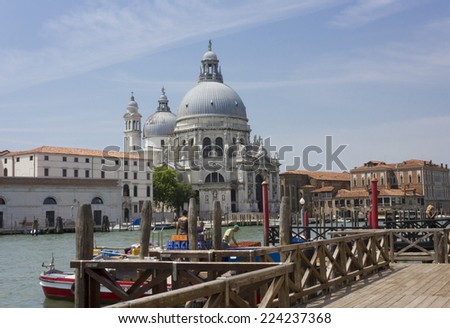 Venice, Italy, June 4 2014: Typical venetian view, facing the Santa Maria della Salute church on the other part of the canal.