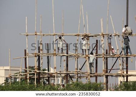 AGRA, INDIA - NOV 27: Workers in a construction site near Agra, with no safety equipment, on November 27 2012