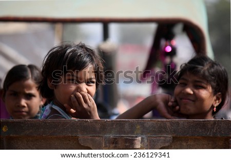 PUSHKAR, INDIA - NOV 28: Children on a truck in Pushkar, going to the famous Camel fair and smiling at the camera on November 28 2012
