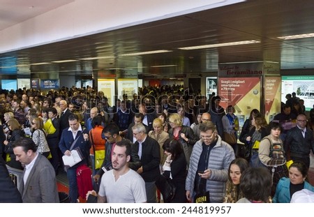 MILAN, ITALY - APR 9: Arriving at Rho Fiera (Milan Trade Fair). Crowd of people at the underground exit going to the Salone del Mobile fairon April 9 2014