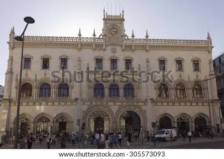 LISBON, PORTUGAL - OCTOBER 23 2014: Rossio Train Station building in Lisbon, with people walking in the street
