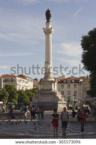 LISBON, PORTUGAL - OCTOBER 23 2014: Pedro IV column in Rossio Square in Lisbon, with people around