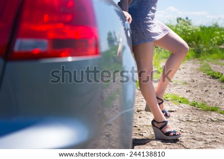 Attractive female legs near the car.