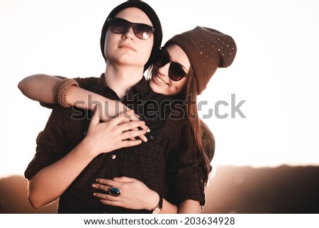 Young fashion hipster couple in love kissing and having passion in spring sunny weather