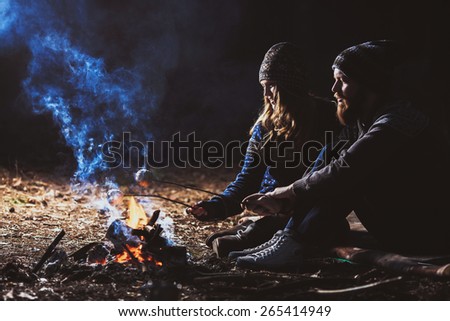 Couple tent camping in the wilderness, low key, soft focus