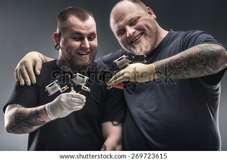 Two mans tattoo artists