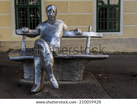 ZAGREB, CROATIA - AUGUST 08, 2014: Strossmayer promenade with metal statue of Antun Gustav Matos, one of Croatia\'s most famous writers made by Ivan Kozaric