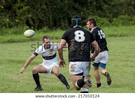 ZAGREB, CROATIA - SEPTEMBER 13, 2014: Rugby match Rugby Club Zagreb in white jersey and Rugby Club Sinj in black jersey. Unidentified player\'s running at each other