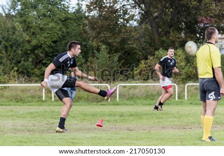 ZAGREB, CROATIA - SEPTEMBER 13, 2014: Rugby match Rugby Club Zagreb in white jersey and Rugby Club Sinj in black jersey. Unidentified player shoots a free kick.