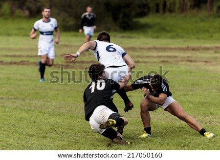 ZAGREB, CROATIA - SEPTEMBER 13, 2014: Rugby match Rugby Club Zagreb in white jersey and Rugby Club Sinj in black jersey. Unidentified player\'s tackle each other