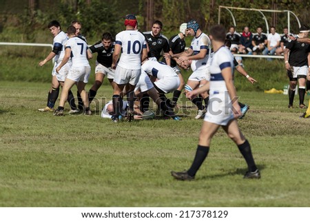 ZAGREB, CROATIA - SEPTEMBER 13, 2014: Rugby match Rugby Club Zagreb in white jersey and Rugby Club Sinj in black jersey. Unidentified player's tackle each other