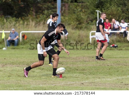 ZAGREB, CROATIA - SEPTEMBER 13, 2014: Rugby match Rugby Club Zagreb in white jersey and Rugby Club Sinj in black jersey. Unidentified player preparing for a free kick.