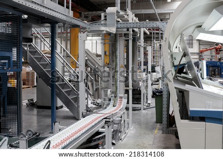 ZAGREB, CROATIA - SEPTEMBER 16, 2014: View of rotation Koenig Bauer machine in Printing house. Semi finished product going through the conveyor belt.