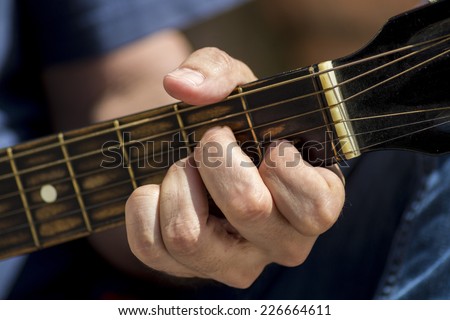 Left hand position of basic chord on the old classic guitar