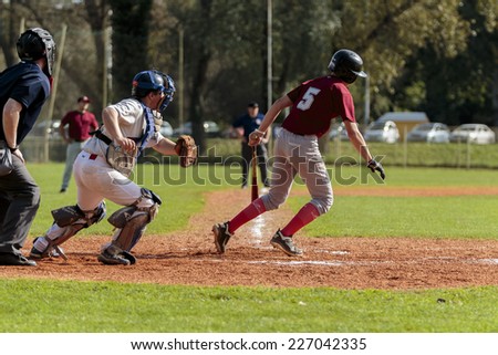 ZAGREB. CROATIA - OCTOBER 11, 2014: Baseball match Baseball Club Zagreb in white jersey and Baseball Club Medvednica in red jersey. Unidentified baseball player running toward first base