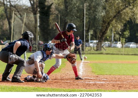 ZAGREB. CROATIA - OCTOBER 11, 2014: Baseball match Baseball Club Zagreb in white jersey and Baseball Club Medvednica in red jersey. Unidentified baseball player has missed the ball