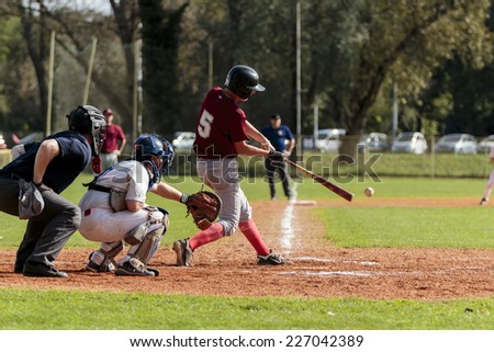 ZAGREB. CROATIA - OCTOBER 11, 2014: Baseball match Baseball Club Zagreb in white jersey and Baseball Club Medvednica in red jersey. Unidentified baseball player hits the ball