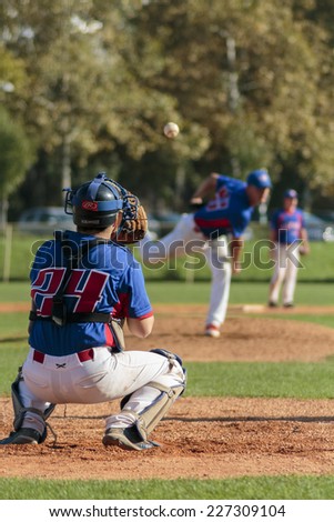 ZAGREB. CROATIA - OCTOBER 12, 2014: Baseball match Baseball Club Zagreb in blue jersey and Baseball Club Olimpija in dark blue jersey. Unidentified baseball players passing the ball to each other