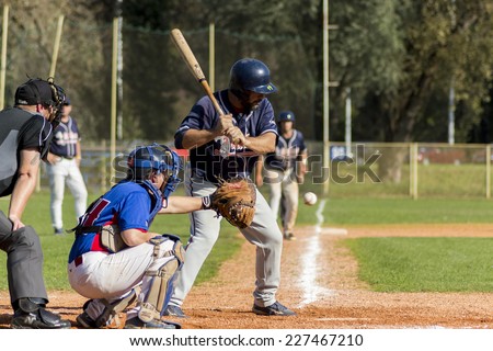 ZAGREB. CROATIA - OCTOBER 12, 2014: Baseball match Baseball Club Zagreb in blue jersey and Baseball Club Olimpija in dark blue jersey. Unidentified baseball catcher is about to catch the ball