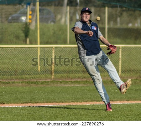 ZAGREB. CROATIA - OCTOBER 12, 2014: Baseball match Baseball Club Zagreb in blue jersey and Baseball Club Olimpija in dark blue jersey. Unidentified baseball player in the field and flying ball